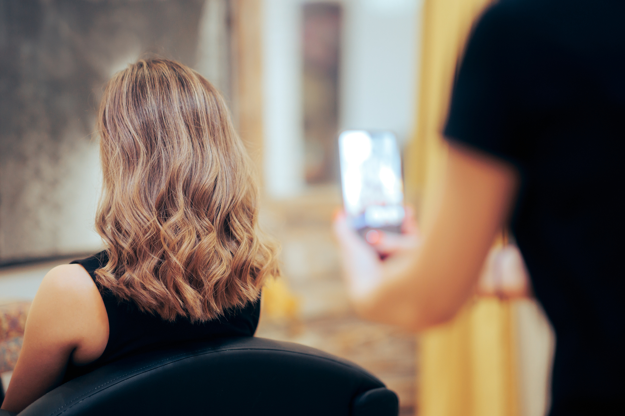 Hairdresser Taking a Picture After Coloring Hair Job